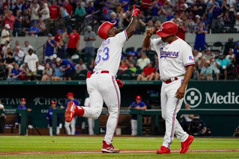 May 17, 2023; Arlington, Texas, USA; Texas Rangers right fielder Adolis Garcia (53) reacts with third base coach Tony Beasley (27) as he circles the bases after hitting a solo home run during the fourth inning against the Atlanta Braves at Globe Life Field. Mandatory Credit: Raymond Carlin III-USA TODAY Sports