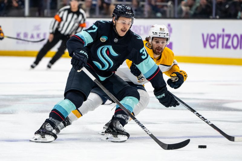 Nov 20, 2024; Seattle, Washington, USA;  Seattle Kraken forward Yanni Gourde (37) skates against Nashville Predators forward Tommy Novak (82) during the first period at Climate Pledge Arena. Mandatory Credit: Stephen Brashear-Imagn Images