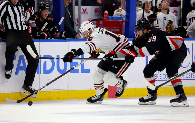 Jan 18, 2024; Buffalo, New York, USA;  Chicago Blackhawks center Jason Dickinson (16) carries the puck up ice as Buffalo Sabres right wing Alex Tuch (89) defends during the first period at KeyBank Center. Mandatory Credit: Timothy T. Ludwig-USA TODAY Sports