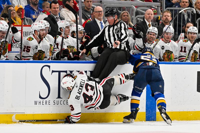 Apr 10, 2024; St. Louis, Missouri, USA;  St. Louis Blues center Zach Dean (52) checks Chicago Blackhawks center Colin Blackwell (43) during the second period at Enterprise Center. Mandatory Credit: Jeff Curry-USA TODAY Sports