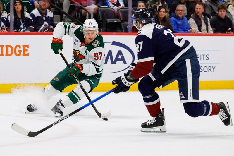 Feb 26, 2026; Denver, Colorado, USA; Minnesota Wild left wing Kirill Kaprizov (97) controls the puck as Colorado Avalanche defenseman Brett Kulak (27) defends in the first period at Ball Arena. Mandatory Credit: Isaiah J. Downing-Imagn Images