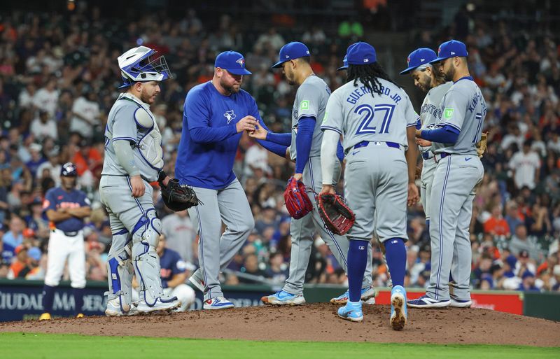 Apr 2, 2024; Houston, Texas, USA; Toronto Blue Jays starting pitcher Jose Berrios (17) hands the ball to manager John Schneider during a pitching change in the seventh inning against the Houston Astros at Minute Maid Park. Mandatory Credit: Troy Taormina-USA TODAY Sports