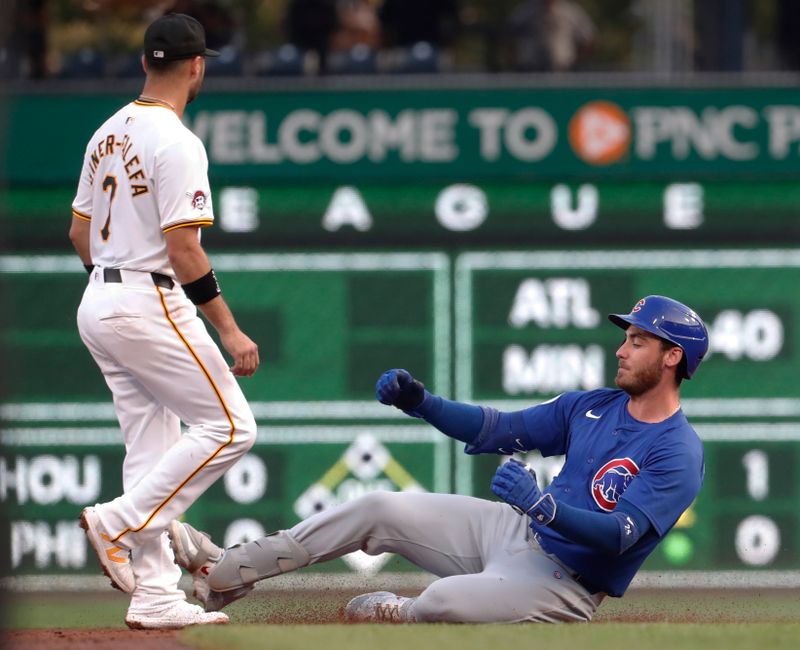 Aug 26, 2024; Pittsburgh, Pennsylvania, USA;  Chicago Cubs right fielder Cody Bellinger (24) arrives at second base with an RBI double as Pittsburgh Pirates shortstop  Isiah Kiner-Falefa (7) looks for a throw during the third inning at PNC Park. Mandatory Credit: Charles LeClaire-USA TODAY Sports