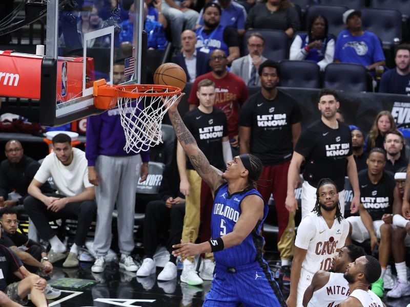 ORLANDO, FL - APRIL 27: Paolo Banchero #5 of the Orlando Magic drives to the basket during the game against the Cleveland Cavaliers during Round 1 Game 4 of the 2024 NBA Playoffs on April 27, 2024 at the Kia Center in Orlando, Florida. NOTE TO USER: User expressly acknowledges and agrees that, by downloading and or using this photograph, User is consenting to the terms and conditions of the Getty Images License Agreement. Mandatory Copyright Notice: Copyright 2024 NBAE (Photo by David Sherman/NBAE via Getty Images)