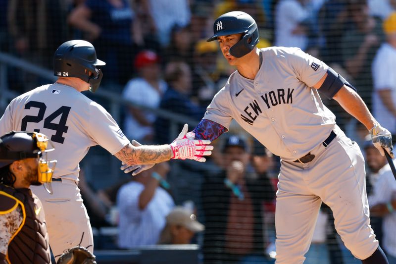 May 26, 2024; San Diego, California, USA; New York Yankees left fielder Alex Verdugo (24) celebrates with New York Yankees designated hitter Giancarlo Stanton (27) after hitting a one run home run in the ninth inning against the San Diego Padres at Petco Park. Mandatory Credit: David Frerker-USA TODAY Sports