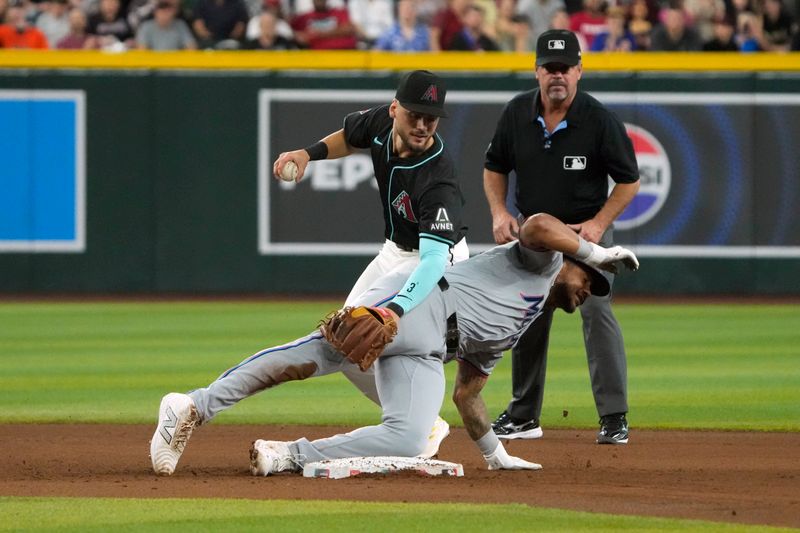 May 26, 2024; Phoenix, Arizona, USA; Arizona Diamondbacks shortstop Blaze Alexander (9) gets the force out on Miami Marlins outfielder Dane Myers (54) in the fifth inning at Chase Field. Mandatory Credit: Rick Scuteri-USA TODAY Sports