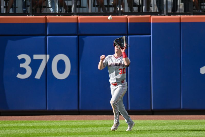 Sep 21, 2025; New York City, New York, USA; Washington Nationals outfielder Jacob Young (30) catches a fly ball hit by New York Mets third baseman Brett Baty (not pictured) during the ninth inning at Citi Field. Mandatory Credit: John Jones-Imagn Images