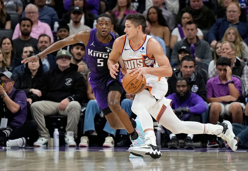 SACRAMENTO, CALIFORNIA - APRIL 12: Grayson Allen #8 of the Phoenix Suns dribbling the ball is guarded by De'Aaron Fox #5 of the Sacramento Kings during the second half of an NBA basketball game at Golden 1 Center on April 12, 2024 in Sacramento, California. NOTE TO USER: User expressly acknowledges and agrees that, by downloading and or using this photograph, User is consenting to the terms and conditions of the Getty Images License Agreement. (Photo by Thearon W. Henderson/Getty Images)