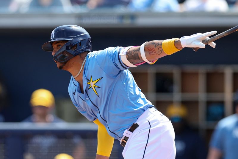 Mar 7, 2024; Port Charlotte, Florida, USA;  Tampa Bay Rays center fielder Jose Siri (22) hits a single against the Philadelphia Phillies in the first inning at Charlotte Sports Park. Mandatory Credit: Nathan Ray Seebeck-USA TODAY Sports