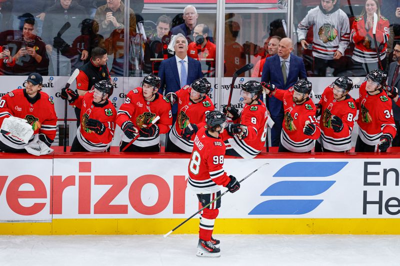 Nov 12, 2025; Chicago, Illinois, USA; Chicago Blackhawks center Connor Bedard (98) celebrates with teammates after scoring against the New Jersey Devils during the first period at United Center. Mandatory Credit: Kamil Krzaczynski-Imagn Images