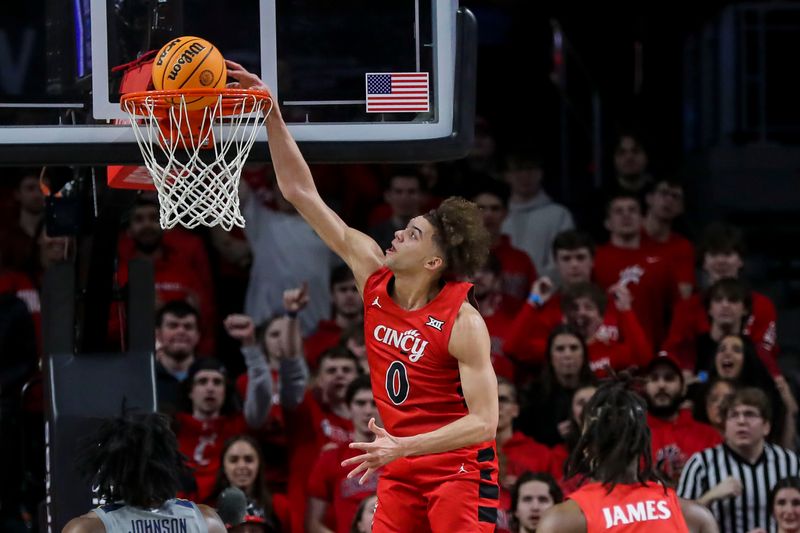 Mar 9, 2024; Cincinnati, Ohio, USA; Cincinnati Bearcats guard Dan Skillings Jr. (0) dunks on the West Virginia Mountaineers in the second half at Fifth Third Arena. Mandatory Credit: Katie Stratman-USA TODAY Sports