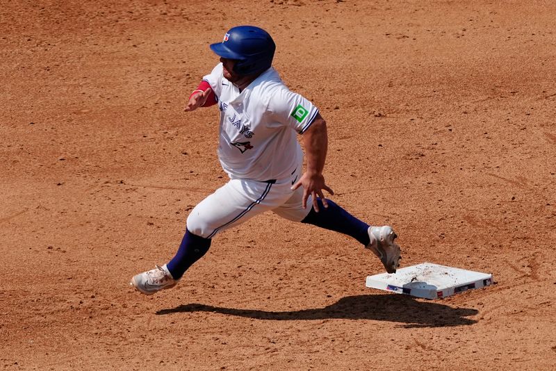 Jul 28, 2024; Toronto, Ontario, CAN; Toronto Blue Jays catcher Alejandro Kirk (30) hreads to third base on a single hit by Toronto Blue Jays center fielder Kevin Kiermaier (not pictured) during the sixth inning against the Texas Rangers at Rogers Centre. Mandatory Credit: John E. Sokolowski-USA TODAY Sports