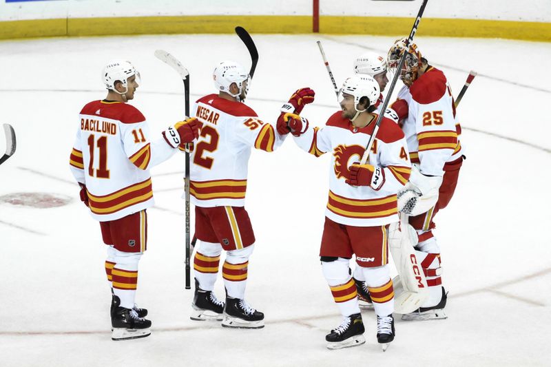 Feb 8, 2024; Newark, New Jersey, USA; Calgary Flames players celebrate after winning against the New Jersey Devils at Prudential Center. Mandatory Credit: John Jones-USA TODAY Sports