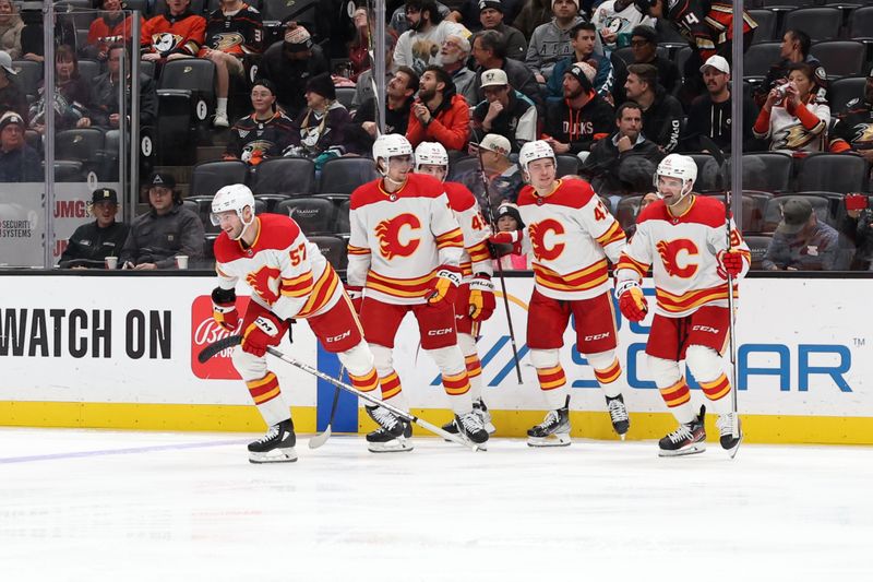 Dec 21, 2023; Anaheim, California, USA;  Calgary Flames defenseman Nick DeSimone (57) celebrates with teammates after scoring a goal during the first period against the Anaheim Ducks at Honda Center. Mandatory Credit: Kiyoshi Mio-USA TODAY Sports