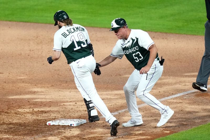 Aug 19, 2023; Denver, Colorado, USA; Colorado Rockies first base coach Ronnie Gideon (53) congratulates designated hitter Charlie Blackmon (19) for his two run home run in the seventh inning against the Chicago White Sox at Coors Field. Mandatory Credit: Ron Chenoy-USA TODAY Sports