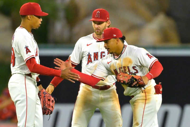 Sep 17, 2024; Anaheim, California, USA;  Los Angeles Angels center fielder Jordyn Adams (39), left fielder Taylor Ward (3) and right fielder Gustavo Campero (51) shake hands as they come off the field after the final out of the ninth inning against the Chicago White Sox at Angel Stadium. Mandatory Credit: Jayne Kamin-Oncea-Imagn Images