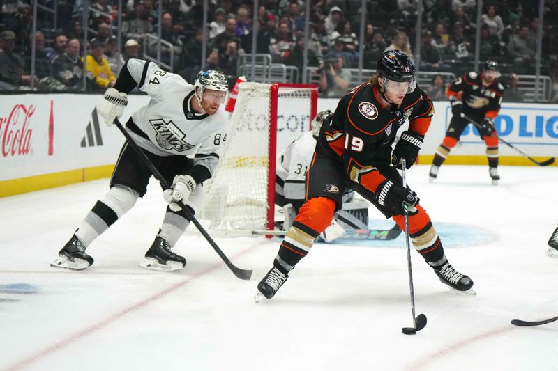 Apr 13, 2024; Los Angeles, California, USA; Anaheim Ducks right wing Troy Terry (19) handles the puck against LA Kings defenseman Vladislav Gavrikov (84) in the first period at Crypto.com Arena. Mandatory Credit: Kirby Lee-USA TODAY Sports