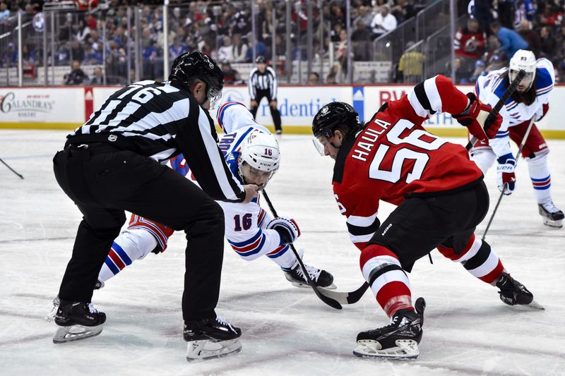 Nov 18, 2023; Newark, New Jersey, USA; New York Rangers center Vincent Trocheck (16) faces off with New Jersey Devils left wing Erik Haula (56) during the first period at Prudential Center. Mandatory Credit: John Jones-USA TODAY Sports