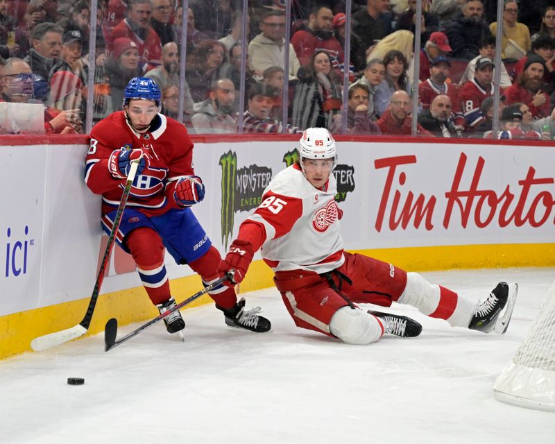 Apr 8, 2025; Montreal, Quebec, CAN; Montreal Canadiens defenseman Lane Hutson (48) avoids a check from Detroit Red Wings forward Elmer Soderblom (85) during the first period at the Bell Centre. Mandatory Credit: Eric Bolte-Imagn Images