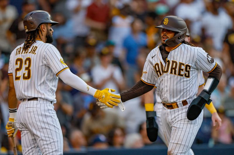 Jul 29, 2023; San Diego, California, USA;  San Diego Padres catcher Luis Campusano (12) celebrates with San Diego Padres right fielder Fernando Tatis Jr. (23) after scoring a run during the second inning against the Texas Rangers at Petco Park. Mandatory Credit: David Frerker-USA TODAY Sports