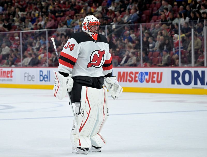 Sep 24, 2024; Montreal, Quebec, CAN; New Jersey Devils goalie Jake Allen (34) skates back to his net during the first period of the game against the Montreal Canadiens at the Bell Centre. Mandatory Credit: Eric Bolte-Imagn Images