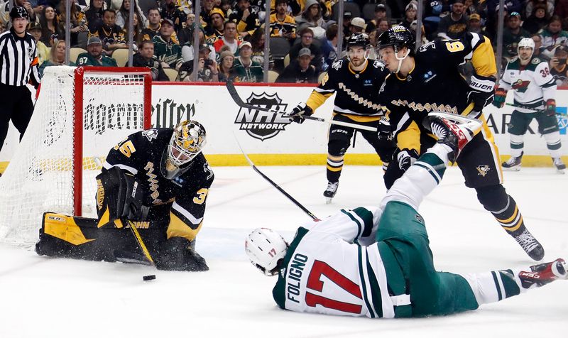 Apr 6, 2023; Pittsburgh, Pennsylvania, USA; Pittsburgh Penguins goaltender Tristan Jarry (35) makes a save against Minnesota Wild left wing Marcus Foligno (17) during the third period at PPG Paints Arena. Pittsburgh won 4-1. Mandatory Credit: Charles LeClaire-USA TODAY Sports