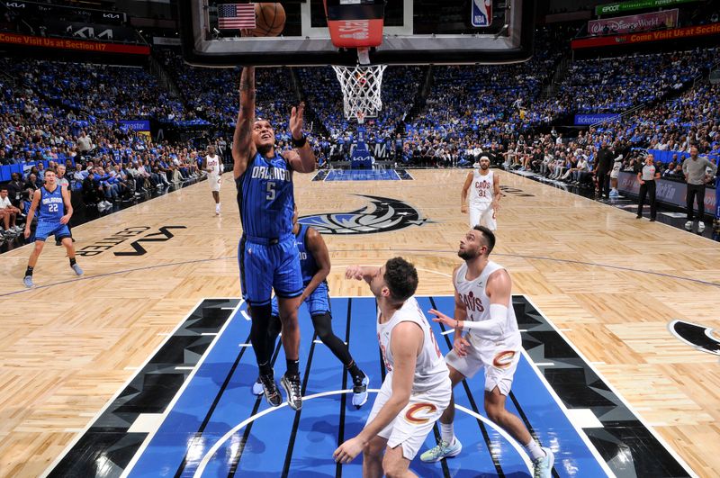 ORLANDO, FL - APRIL 25: Paolo Banchero #5 of the Orlando Magic goes to the basket during the game against the Cleveland Cavaliers during Round 1 Game 3 of the 2024 NBA Playoffs on April 25, 2024 at Kia Center in Orlando, Florida. NOTE TO USER: User expressly acknowledges and agrees that, by downloading and or using this photograph, User is consenting to the terms and conditions of the Getty Images License Agreement. Mandatory Copyright Notice: Copyright 2023 NBAE (Photo by Fernando Medina/NBAE via Getty Images)