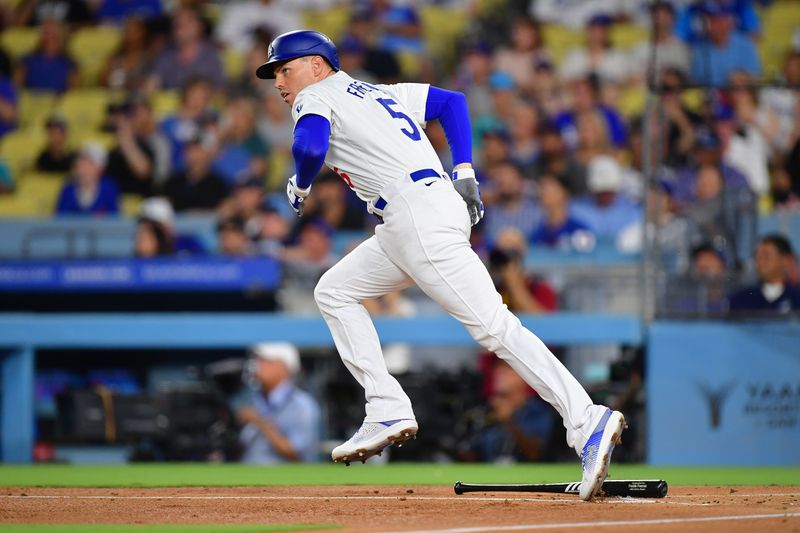 Sep 9, 2024; Los Angeles, California, USA; Los Angeles Dodgers first baseman Freddie Freeman (5) hits a single against the Chicago Cubs during the first inning at Dodger Stadium. Mandatory Credit: Gary A. Vasquez-Imagn Images