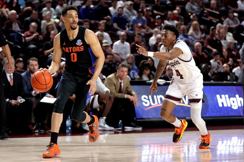 Jan 18, 2023; College Station, Texas, USA; Florida Gators guard Myreon Jones (0) handles the ball while Texas A&M Aggies guard Wade Taylor IV (4) defends during the first half at Reed Arena. Mandatory Credit: Erik Williams-USA TODAY Sports
