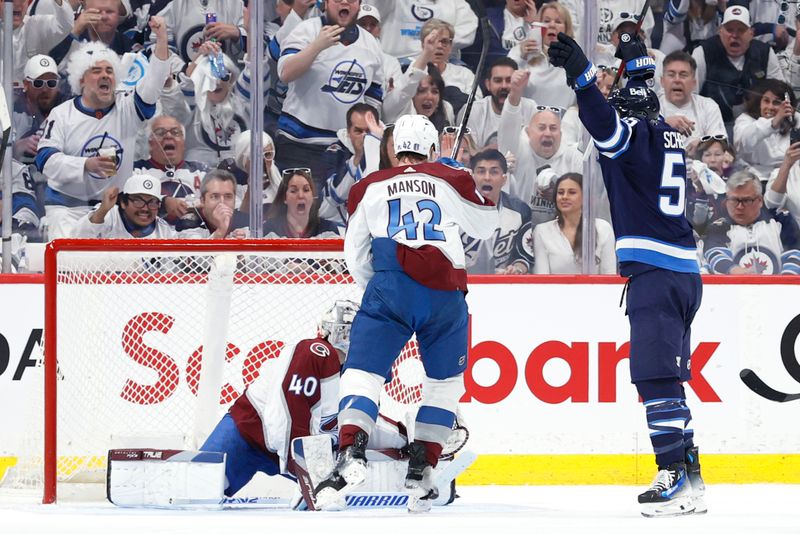 Apr 21, 2024; Winnipeg, Manitoba, CAN;wh55 celebrates his first period goal on Colorado Avalanche goaltender Alexandar Georgiev (40)  in game one of the first round of the 2024 Stanley Cup Playoffs at Canada Life Centre. Mandatory Credit: James Carey Lauder-USA TODAY Sports