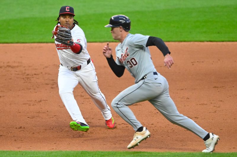 May 6, 2024; Cleveland, Ohio, USA; Detroit Tigers right fielder Kerry Carpenter (30) runs by the tag attempt of Cleveland Guardians third baseman Jose Ramirez (11) in the eighth inning at Progressive Field. Mandatory Credit: David Richard-USA TODAY Sports