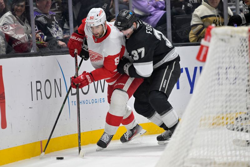 Nov 16, 2024; Los Angeles, California, USA; Detroit Red Wings center Joe Veleno (90) and Los Angeles Kings left wing Warren Foegele (37) battle for the puck in the second period at Crypto.com Arena. Mandatory Credit: Jayne Kamin-Oncea-Imagn Images