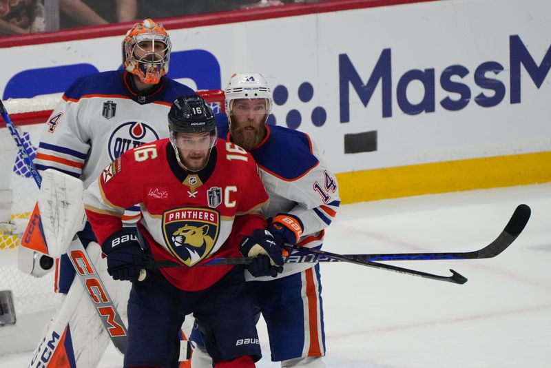 Jun 24, 2024; Sunrise, Florida, USA; Edmonton Oilers defenseman Mattias Ekholm (14) defends against Florida Panthers forward Aleksander Barkov (16) during the first period n game seven of the 2024 Stanley Cup Final at Amerant Bank Arena. Mandatory Credit: Jim Rassol-USA TODAY Sports