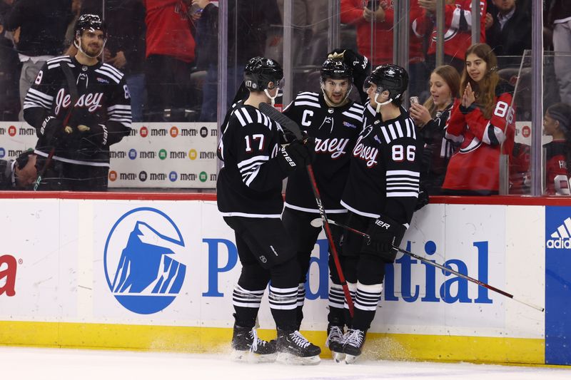 Mar 9, 2024; Newark, New Jersey, USA; New Jersey Devils center Nico Hischier (13) celebrates his goal against the Carolina Hurricanes during the second period at Prudential Center. Mandatory Credit: Ed Mulholland-USA TODAY Sports