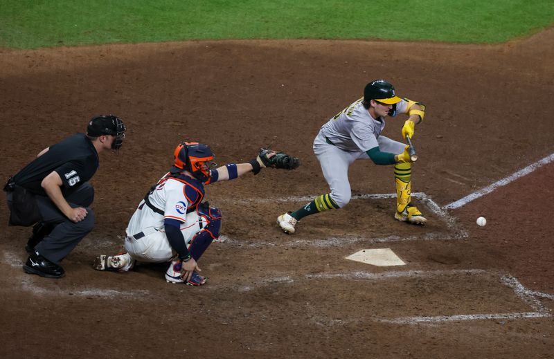 Sep 10, 2024; Houston, Texas, USA; Oakland Athletics shortstop Jacob Wilson (5) bunts safely against the Houston Astros in the 10th inning at Minute Maid Park. Mandatory Credit: Thomas Shea-Imagn Images