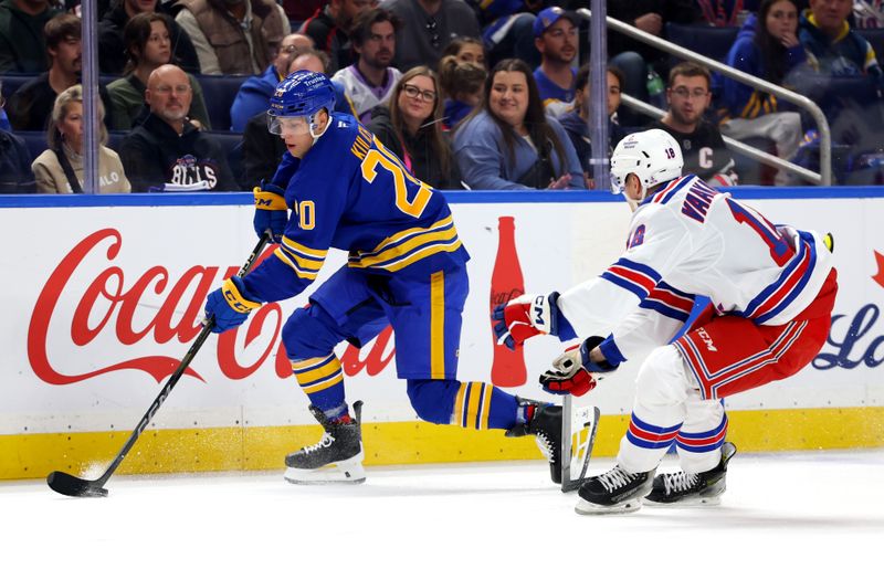 Oct 9, 2025; Buffalo, New York, USA;  Buffalo Sabres center Jiri Kulich (20) skates with the puck as New York Rangers defenseman Urho Vaakanainen (18) defends during the first period at KeyBank Center. Mandatory Credit: Timothy T. Ludwig-Imagn Images