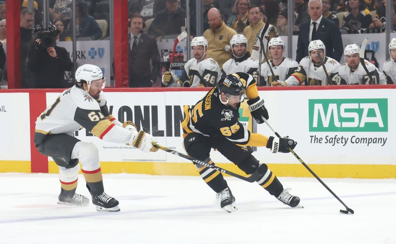 Mar 11, 2025; Pittsburgh, Pennsylvania, USA;  Pittsburgh Penguins defenseman Erik Karlsson (65) moves the puck against Vegas Golden Knights right wing Mark Stone (61) during the first period at PPG Paints Arena. Mandatory Credit: Charles LeClaire-Imagn Images