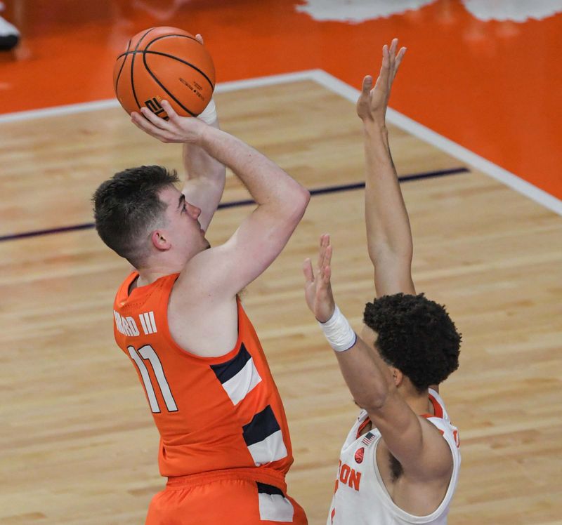 Feb 22, 2023; Clemson, South Carolina, USA; Syracuse guard Joseph Girard III (11) shoots the ball against Clemson junior guard Chase Hunter (1) during the first half at Littlejohn Coliseum. Mandatory Credit: Ken Ruinard-USA TODAY Sports