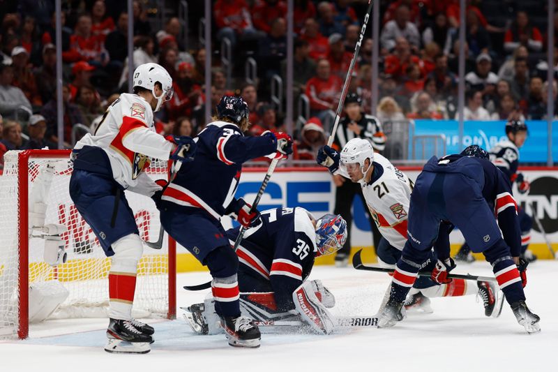 Nov 8, 2023; Washington, District of Columbia, USA; Washington Capitals goaltender Darcy Kuemper (35) makes a save in front of Florida Panthers center Nick Cousins (21) in the second period at Capital One Arena. Mandatory Credit: Geoff Burke-USA TODAY Sports