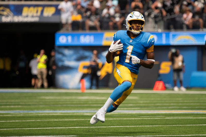 Los Angeles Chargers wide receiver Quentin Johnston (1) runs with the ball during an NFL football game against the Las Vegas Raiders, Sunday, Sept. 8, 2024, in Inglewood, Calif. (AP Photo/Kyusung Gong)