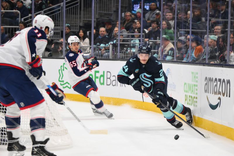 Nov 11, 2025; Seattle, Washington, USA; Seattle Kraken defenseman Jamie Oleksiak (24) plays the puck during the first period against the Columbus Blue Jackets at Climate Pledge Arena. Mandatory Credit: Steven Bisig-Imagn Images