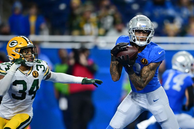 Detroit Lions wide receiver Josh Reynolds, defended by Green Bay Packers safety Jonathan Owens (34), catches a 12-yard pass for a touchdown during the second half of an NFL football game, Thursday, Nov. 23, 2023, in Detroit. (AP Photo/David Dermer)