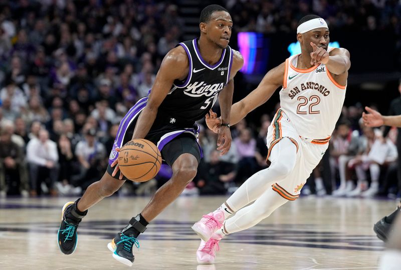 SACRAMENTO, CALIFORNIA - MARCH 07: De'Aaron Fox #5 of the Sacramento Kings drives to the basket past Malaki Branham #22 of the San Antonio Spurs during the second half at Golden 1 Center on March 07, 2024 in Sacramento, California. NOTE TO USER: User expressly acknowledges and agrees that, by downloading and or using this photograph, User is consenting to the terms and conditions of the Getty Images License Agreement. (Photo by Thearon W. Henderson/Getty Images)