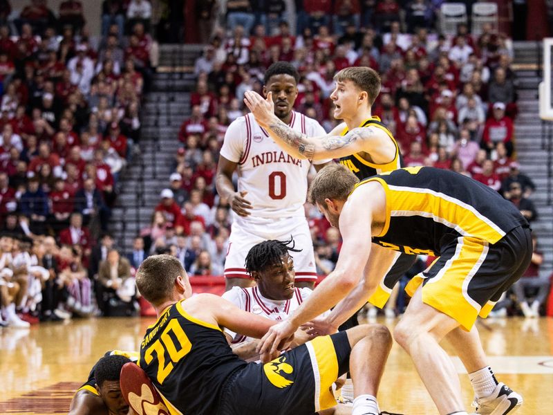 Jan 30, 2024; Bloomington, Indiana, USA; Indiana Hoosiers forward Anthony Walker (4) and Iowa Hawkeyes guard Tony Perkins (11) fight for the ball in the first half at Simon Skjodt Assembly Hall. Mandatory Credit: Trevor Ruszkowski-USA TODAY Sports