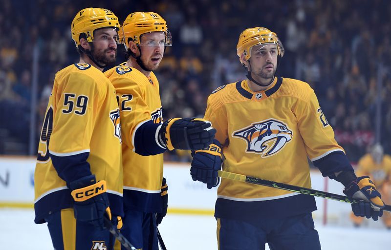 Jan 26, 2023; Nashville, Tennessee, USA; Nashville Predators center Ryan Johansen (92) talks with defenseman Roman Josi (59) and right wing Nino Niederreiter (22) before a play during the first period against the New Jersey Devils at Bridgestone Arena. Mandatory Credit: Christopher Hanewinckel-USA TODAY Sports