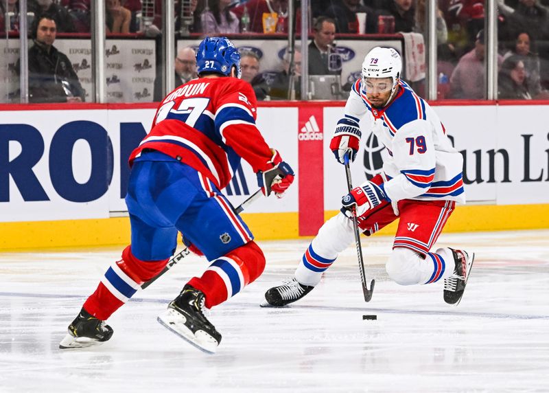 Mar 9, 2023; Montreal, Quebec, CAN; New York Rangers defenseman K'Andre Miller (79) plays the puck against Montreal Canadiens left wing Jonathan Drouin (27) during the third period at Bell Centre. Mandatory Credit: David Kirouac-USA TODAY Sports