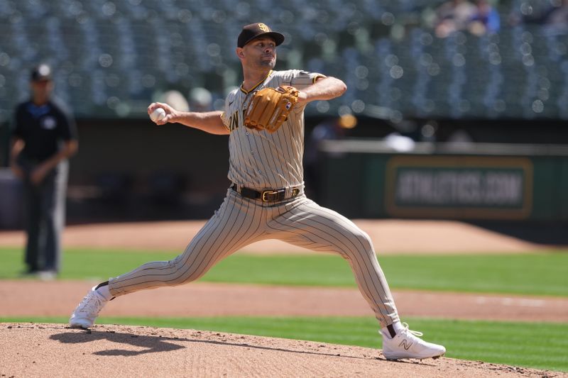 Sep 17, 2023; Oakland, California, USA; San Diego Padres starting pitcher Nick Martinez (21) throws a pitch against the Oakland Athletics during the first inning at Oakland-Alameda County Coliseum. Mandatory Credit: Darren Yamashita-USA TODAY Sports