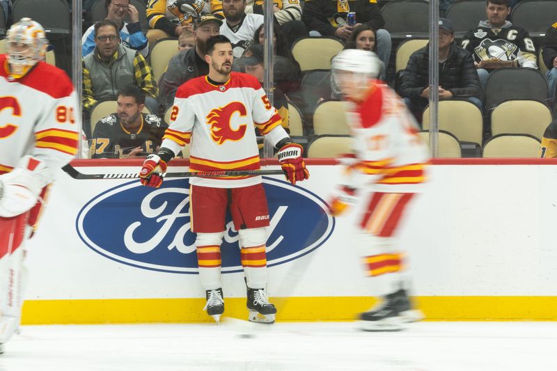 Oct 14, 2023; Pittsburgh, Pennsylvania, USA; Calgary Flames defenseman MacKenzie Weegar (52) watches along the boards as his teammates skate around during warm up before the game against the Pittsburgh Penguins at PPG Paints Arena. Mandatory Credit: Scott Galvin-USA TODAY Sports