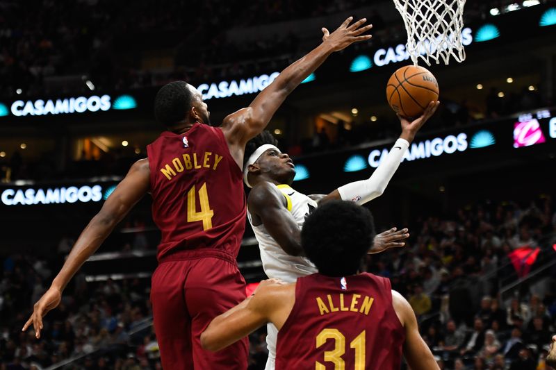 SALT LAKE CITY, UTAH - APRIL 02: Taylor Hendricks #0 of the Utah Jazz shoots over Evan Mobley #4 of the Cleveland Cavaliers during the first half of a game at Delta Center on April 02, 2024 in Salt Lake City, Utah. NOTE TO USER: User expressly acknowledges and agrees that, by downloading and or using this photograph, User is consenting to the terms and conditions of the Getty Images License Agreement. (Photo by Alex Goodlett/Getty Images)