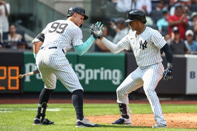 Aug 25, 2024; Bronx, New York, USA;  New York Yankees right fielder Juan Soto (22) celebrates with New York Yankees center fielder Aaron Judge (99) after hitting a solo home run in the seventh inning against the Colorado Rockies at Yankee Stadium. Mandatory Credit: Wendell Cruz-USA TODAY Sports